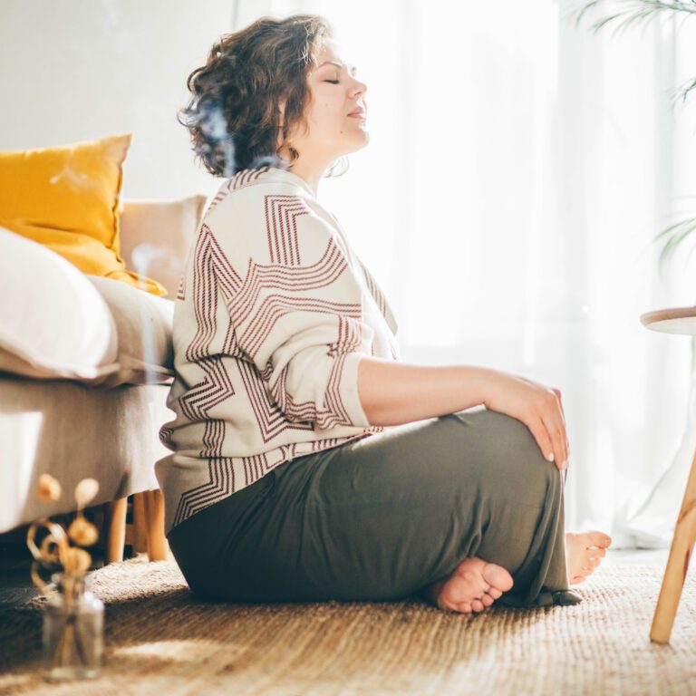 Plus size woman doing yoga and meditation at home.