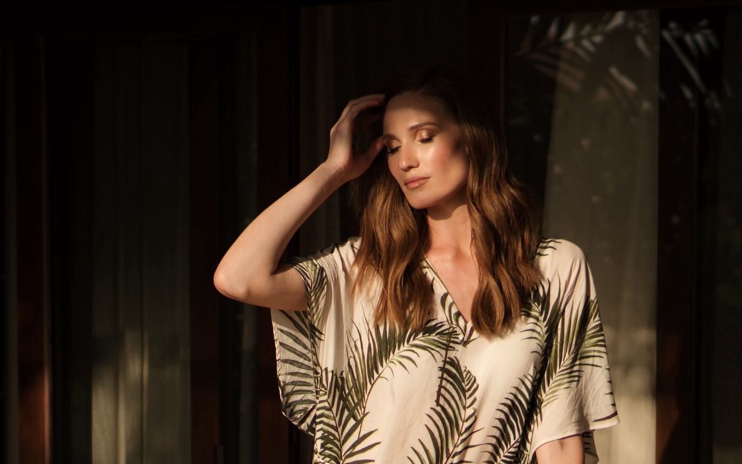 Fashionable portrait of a beautiful woman in a tropical villa