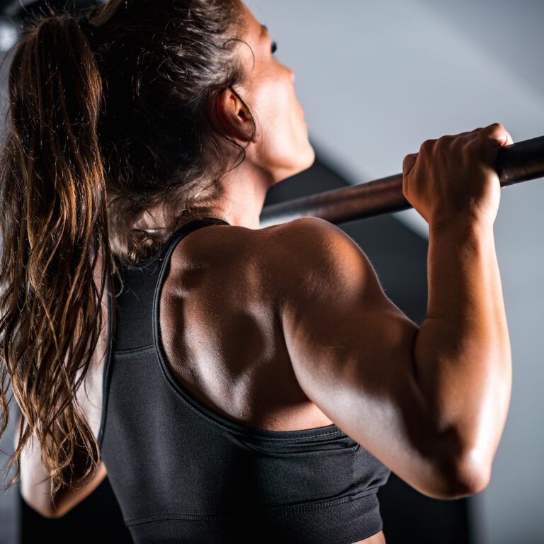 Woman athlete doing pull ups
