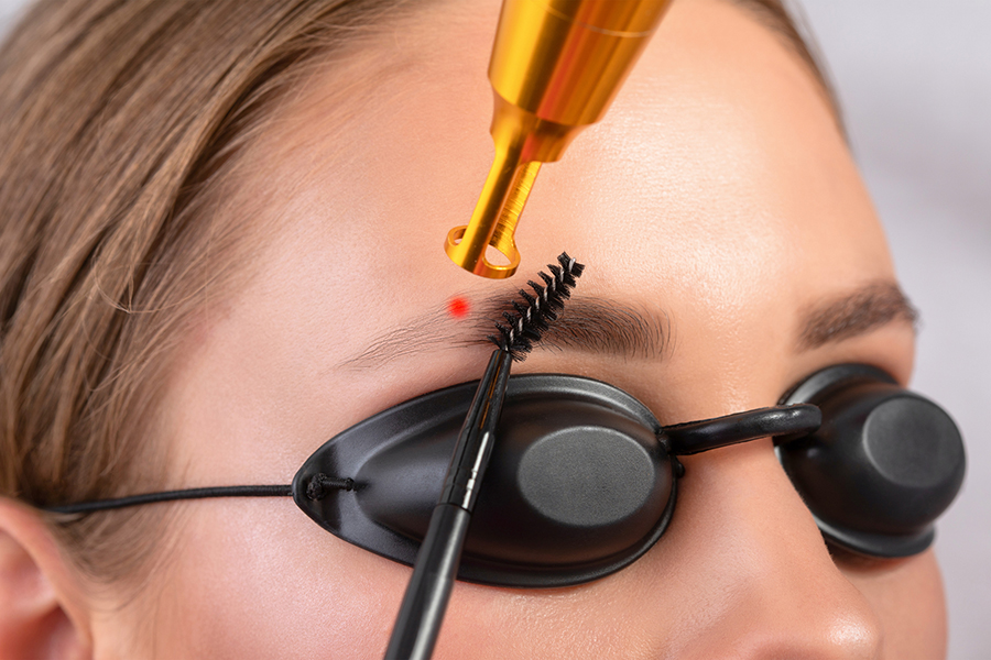 Removal of permanent makeup on the eyebrows.Carbon face peeling in a beauty salon. Hardware cosmetology treatment.