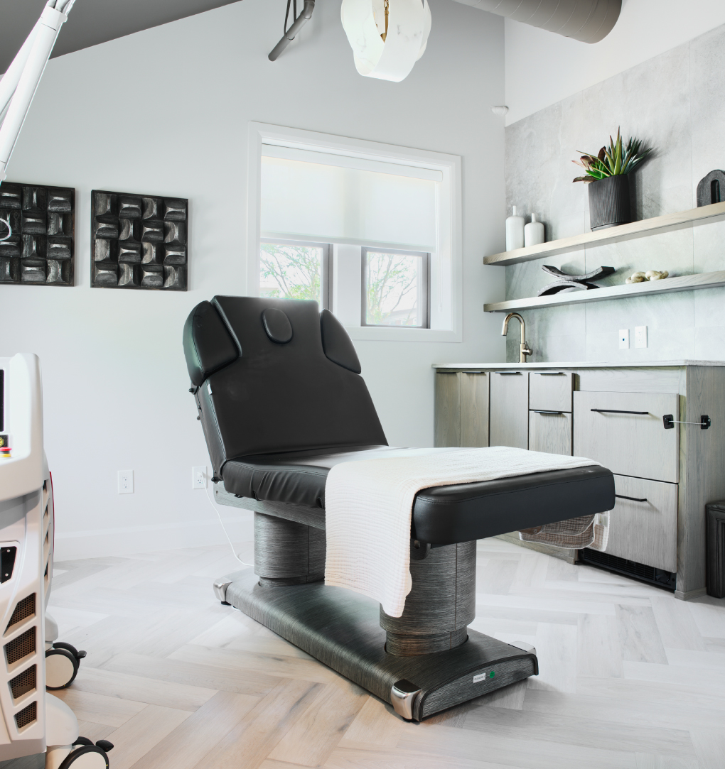 Modern med spa treatment room in Westerville with advanced laser equipment and luxury design.