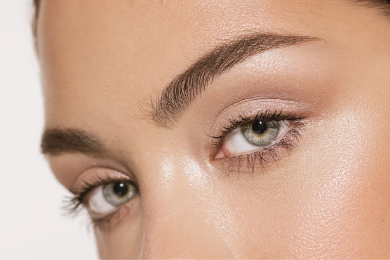Close-up of a woman's smooth, bright under-eye area with no hollows or dark circles